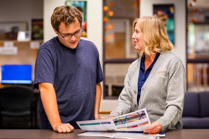 An advisor is speaking with a student at the CCBC Student Services Office. 