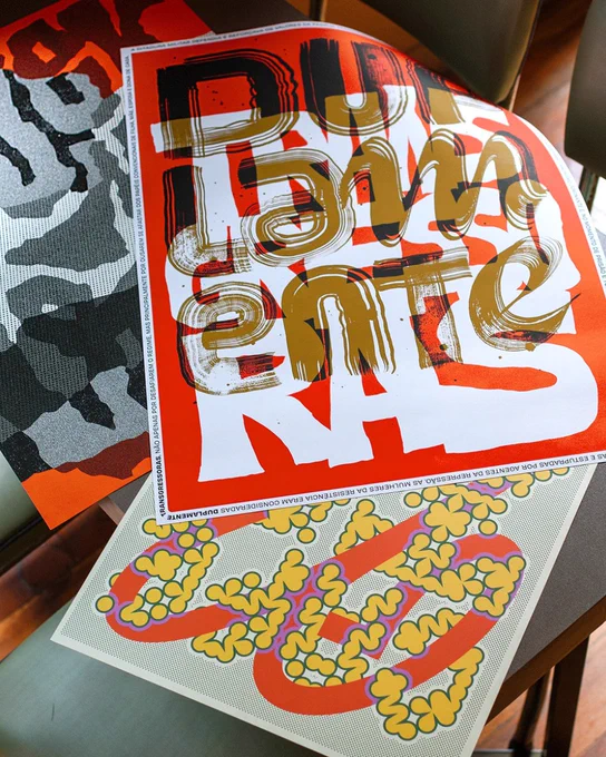 Posters by Brazilian designer Cyla Costa — examples of type used in innovative ways. Posters include orange, black, yellow, white, and other colors.