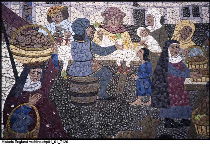 A colour photograph of a mosaic depicting a market scene. On the left is a woman holding a basket of produce on her head. In the centre, a man with a maroon hat is holding poultry in front of two customers. On the right, two woman hold baskets of produce. The people wear clothes of maroon, blue, yellow, and white. 