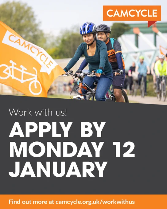 Picture of two cyclists wearing helmets at the front of a group of riders on the way to Reach Fair. A Camcycle flag flutters in front of them. 

Text reads: Work with us! Apply by Monday 12 January. Find out more at camcycle.org.uk/workwithus