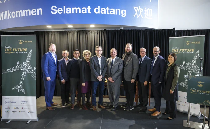 From left, Bill McSherry, Guy Palumbo, Joe Nguyen, Elizabeth Cantwell, Gov. Bob Ferguson, Exec. Dave Somers, Sen. Marko Liias, Tim Zenk, Ryan Spies, and Rep. Mia Gregerson pose for a photo during the launch event for the Cascadia Sustainable Aviation Accelerator (CSAA) at the Boeing Future of Flight in Mukilteo, Wash. on Thursday, Jan. 8, 2026.