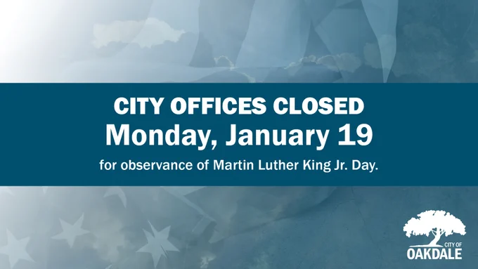 graphic with  images of a US flag over concrete and clouds in the sky with  blue overlay with blue band across the middle and white text that reads "CITY OFFICES CLOSED Monday, January 19 for observance of Martin Luther King Jr. Day." and white logo in bottom right with white tree and text that reads "CITY OF OAKDALE"