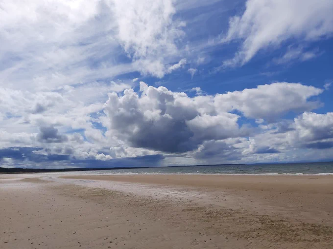 An expanding sky, sea and beach scene which evokes a feeling of possibility