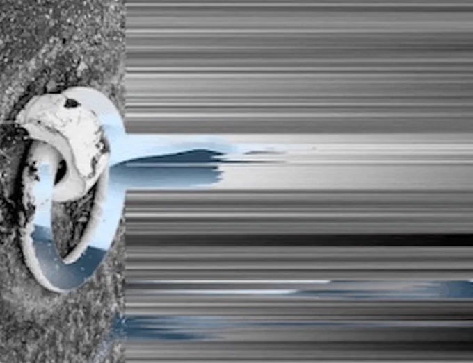 Pixel stretched image of ... something. A bone? A bunch of gray textures? I have no idea! But it's the cover of the compilation.