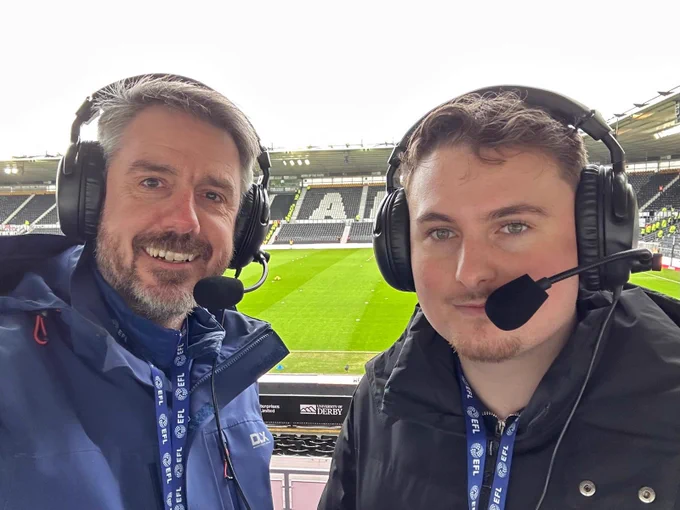 Landscape selfie of today’s AD commentary team Robin and special guest Kieran! In the background in the middle of the photo between our commentators is a section of the South side of the pitch and a little bit of East stand visible as well