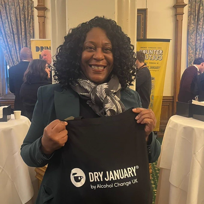 Juliet Campbell holding a bag that says "Dry January by Alcohol Change UK"