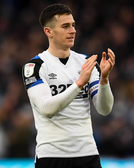 Tom Lawrence applauding fans and donning the captain's armband for Derby County during the 2021/22 season.