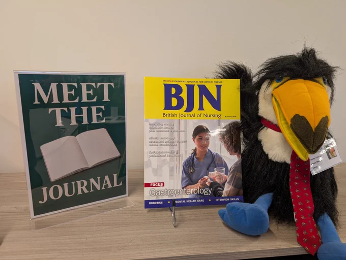 Library mascot with a copy of the British Journal of Nursing 