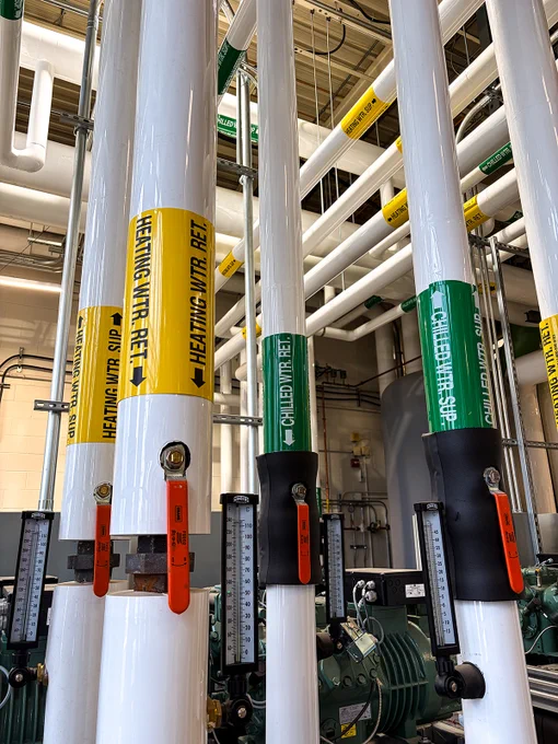 A series of pipes with different colour labels on them.
