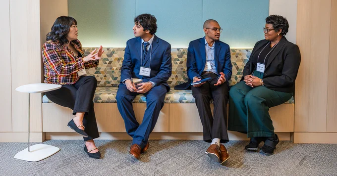 Image of Spectrum Scholars talking in a small group at the office