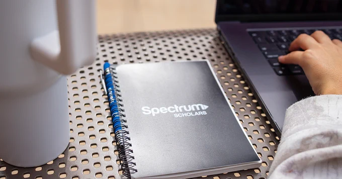 Spectrum Scholars notebook on a desk