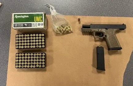 Photo of handgun next to ammo