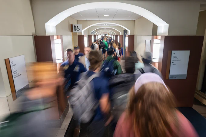 Students make their way through DeBartolo Hall on the first day of class. The scene captures motion blur to emphasize movement.
