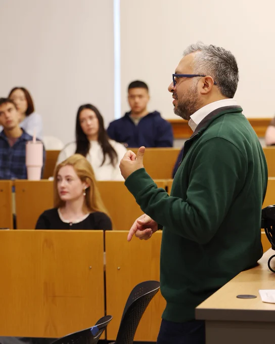 A UVA professor discusses with students during class.