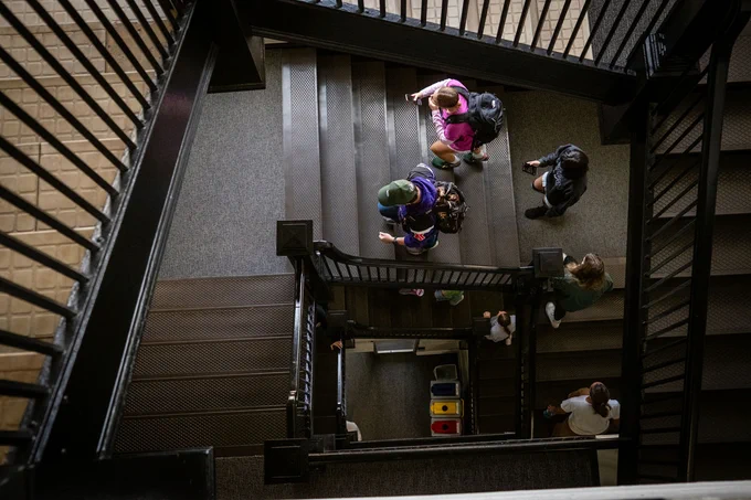 Students climb the stairs in the admin building.