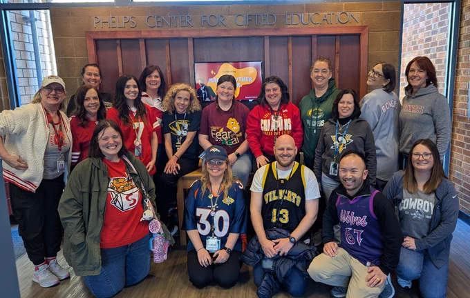 Group of people wearing various sports shirts and jerseys 
