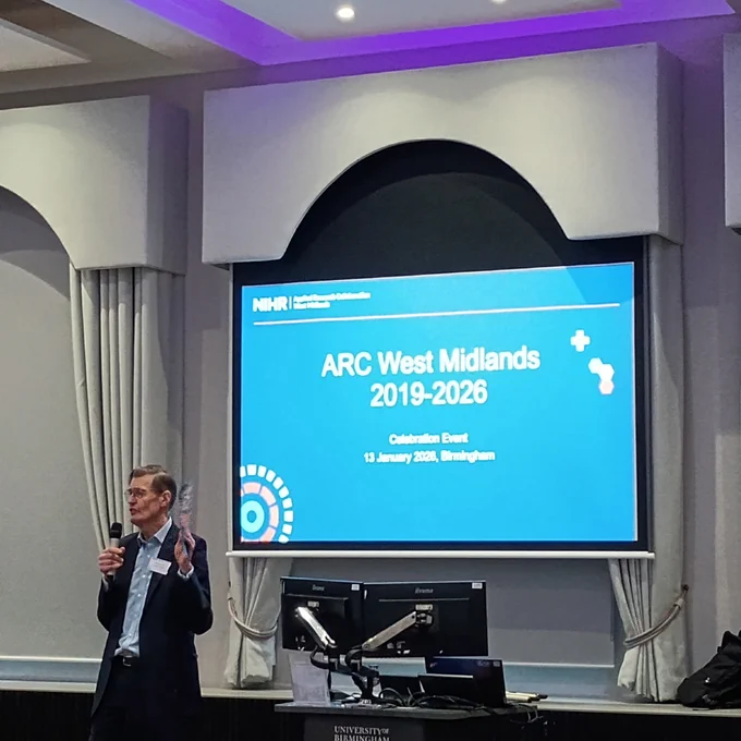 Prof Richard Lilford talking in front of a screen stating 'ARC West Midlands 2019-2026 Celebration Event'