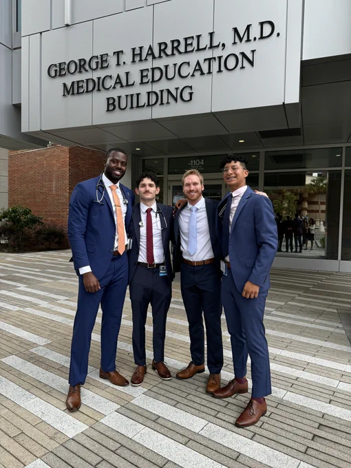 Michael Lafferty and three classmates outside the Harrell Medical Education Building.