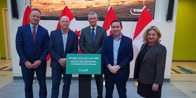 Officials from NRCan and funding recipients pose at the funding announcement. 