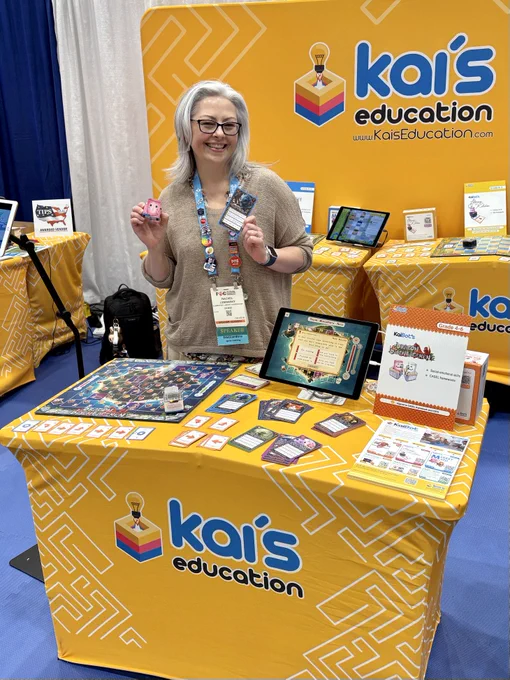 Rachel Lemansky holding a KaiBot in front of the Kai's Education booth
