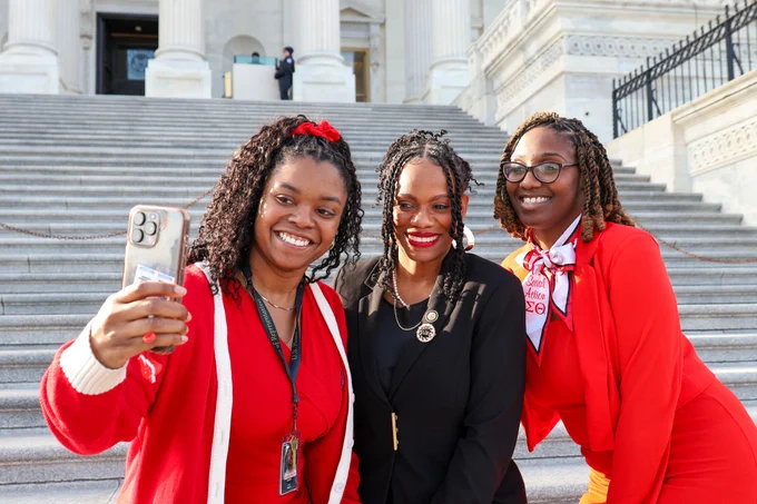 Rep. Lee takes a picture with two deltas.