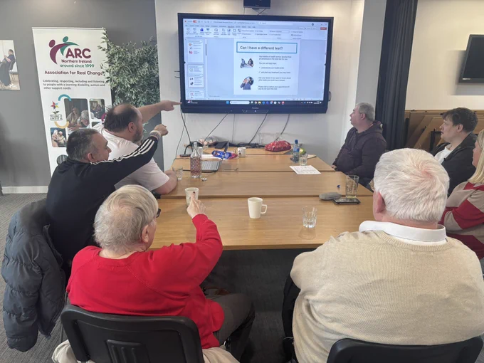 Group photo of TILII Belfast working on the easy read