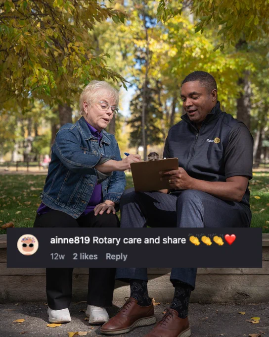 Two individuals sitting on a park bench, one holding a clipboard and discussing with the other. The post is tagged with "Rotary care and share" on a social media platform.