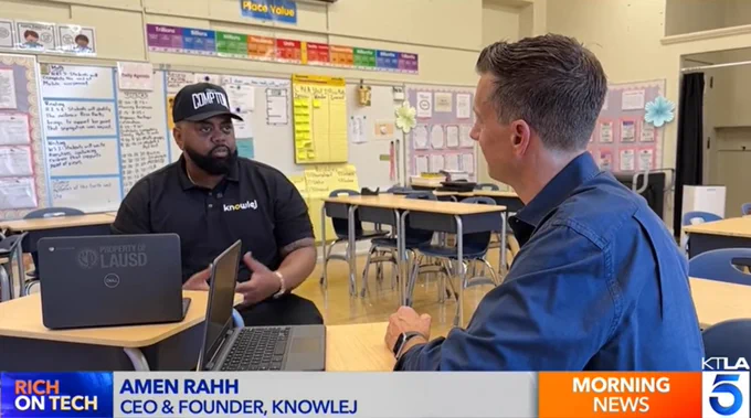 Amen Rahh talking with Rich DeMuro during interview in classroom for report on Knowlej