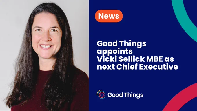 To the left is a photo of Vicki smiling towards the camera. On a navy blue background, bold white text in an orange rounded shape reads: "News. Below bold white text reads: "Good Things appoints Vicki Sellick MBE as next Chief Executive." Good Things logo below. Two separate curved lines - one teal at the top right and one red at the bottom right.