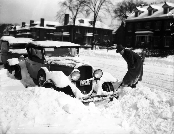 A man digs his car out of a snowbank in a residential neighborhood, March 27, 1934. Courtesy: Detroit News Collection [UAV002691]