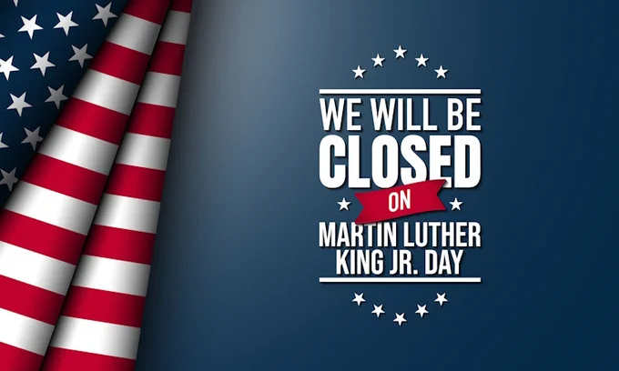 A professional holiday announcement graphic for Fuller Insurance featuring a stylized American flag on the left side. The text on a dark blue background reads "WE WILL BE CLOSED ON MARTIN LUTHER KING JR. DAY" in bold white lettering, accented by white stars and a red ribbon detail.