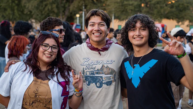 Three TAMIU Students posing and smiling for the camera.