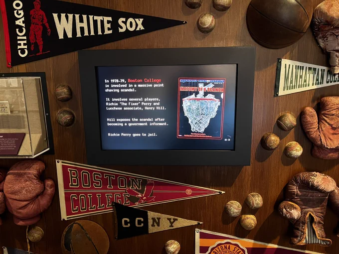 A display at The Mob Museum in Las Vegas explaining the point shaving scandal of 1978-1979, featuring pennants from Boston College, CCNY, and Arizona State.
