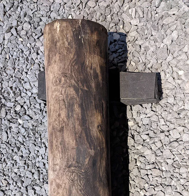 The end of the pump, a very long wooden tree trunk that's hollowed out down the middle.