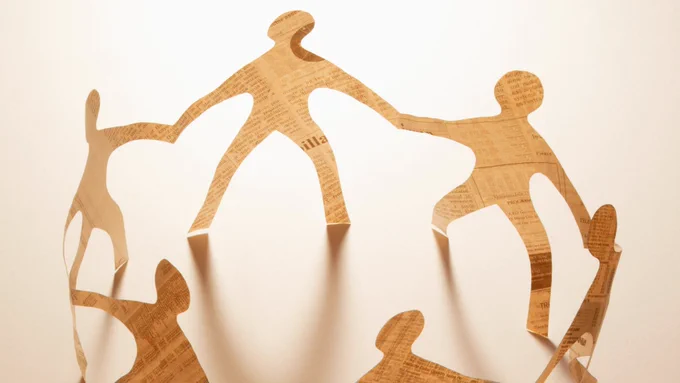 A paper chain of connected figures