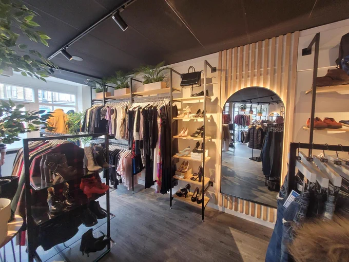 Inside the Yorkshire Cancer Research shop in Skipton, the charity's first fashion-only store. A mirror is visible, along with an array of clothing and accessories.