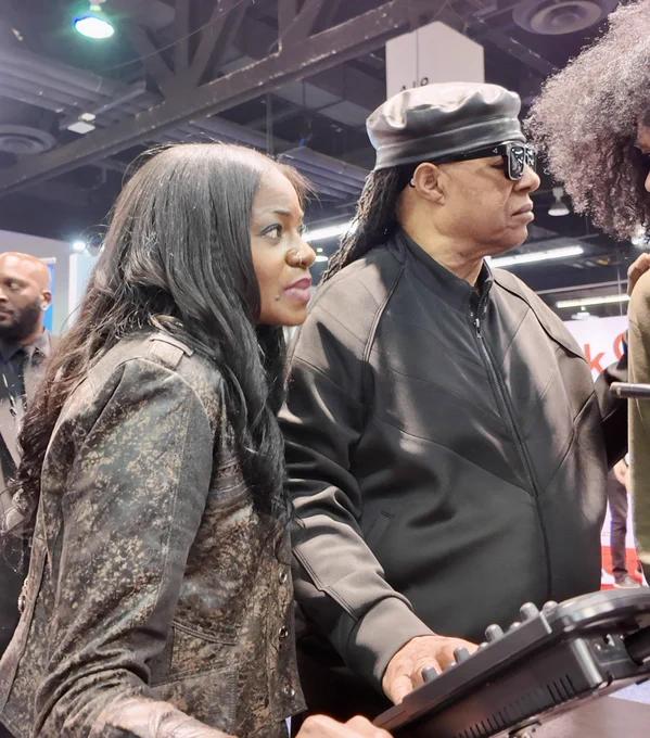 Stevie Wonder and a Hear Tech team member at HT’s trade show booth.