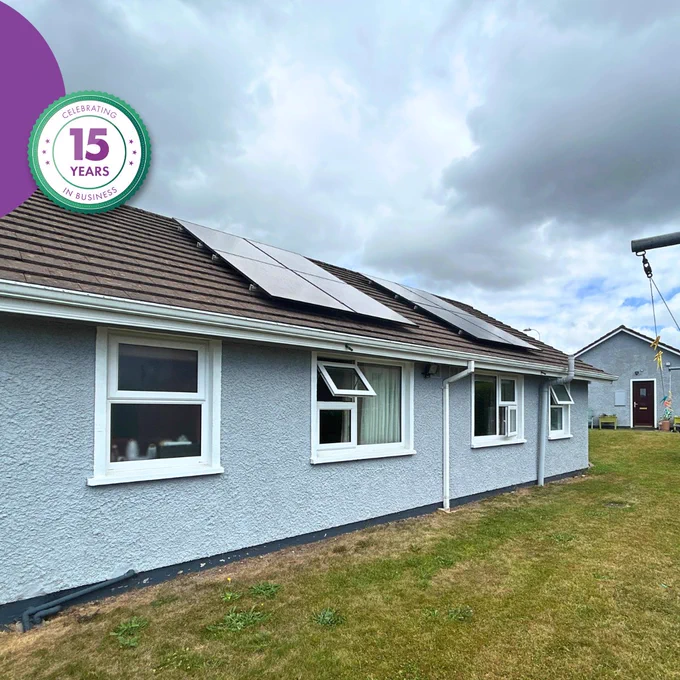 Single-storey home with roof-mounted solar PV panels installed as part of a community retrofit project.