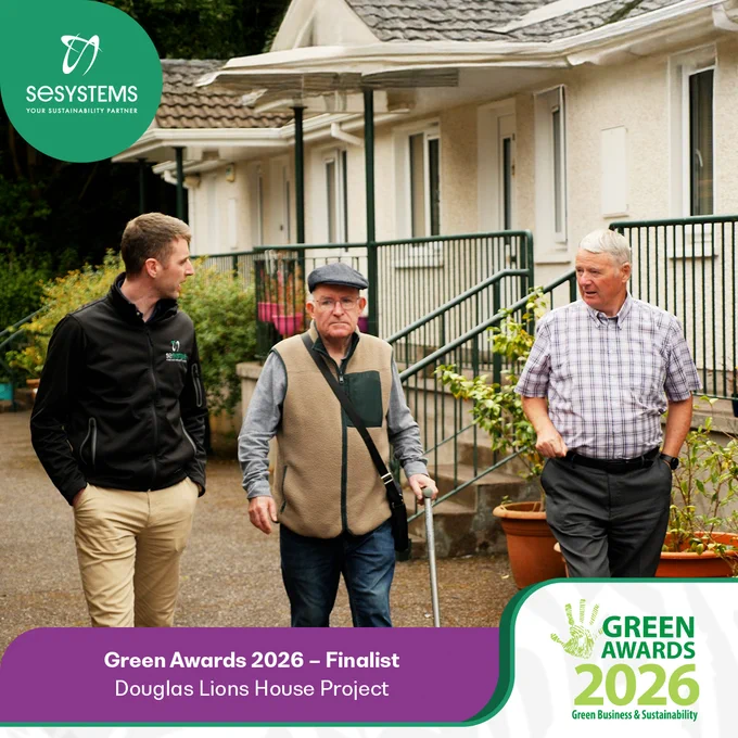 SE Systems team member walking with residents at Douglas Lions House, Cork, highlighting the Green Awards 2026 finalist recognition for the Douglas Lions House community energy retrofit project.