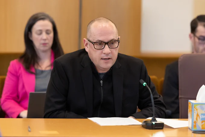 Image of one person presenting at a board meeting.