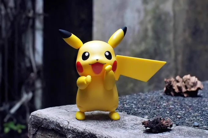 A toy plastic figure of Pikachu smiling