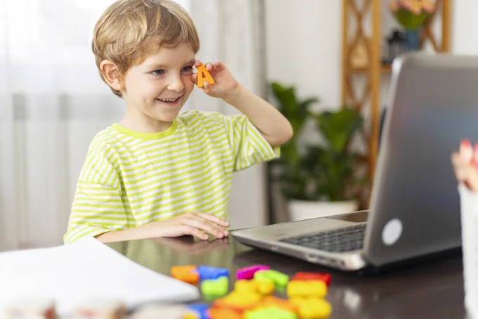 A boy sitting at a laptop