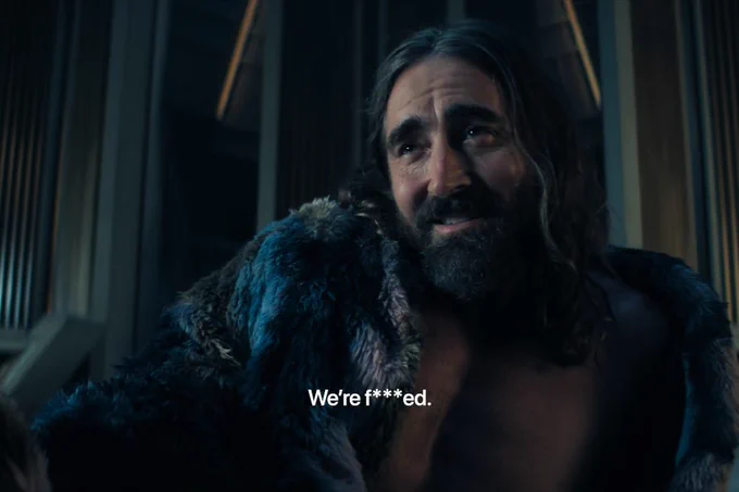 From Foundation. Lee Pace as Brother Day sits in a fur coat. Text on the image indicates he is saying, "We're f***ed."