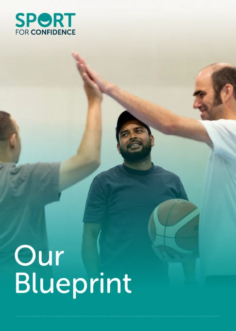 Front cover of the Sport for Confidence Blueprint document. Two men giving each other a High Five while another man looks on. Sport for Confidence logo is in the top left hand corner with the title 'Our Blueprint' in white text in the bottom left corner. 