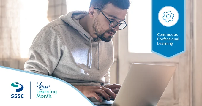 Person in a gray hoodie typing on a laptop in a softly lit room with a banner promoting continuous professional learning.