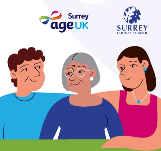 Three people sitting together: a man with short brown hair in a blue shirt, an older woman with grey hair in a dark blue shirt, and a woman with long brown hair in a pink top with turquoise jewellery. Logos for Surrey Age UK and Surrey County Council appear above.