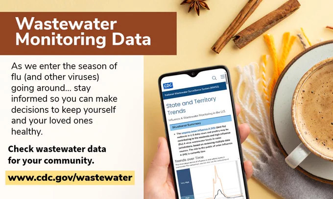 A phone showing state and territory trends of influenza data being held near a cup coffee. With the text “Wastewater Monitoring Data. As we enter the season of flu (and other viruses) going around... stay informed so you can make decisions to keep yourself and your loved ones healthy. Check wastewater data for your community. www.cdc.gov/wastewater”