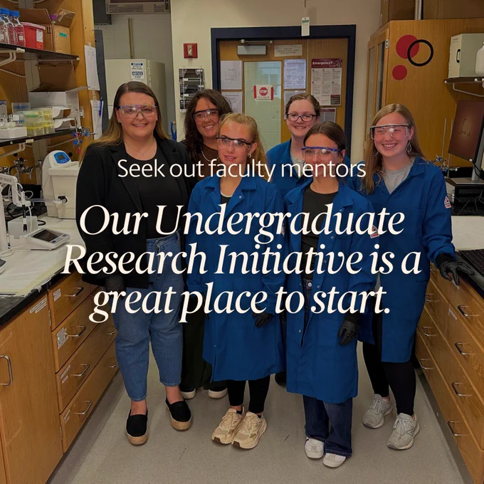 Group of five people in lab coats standing in a laboratory, with text overlay saying 'Seek out faculty mentors. Our Undergraduate Research Initiative is a great place to start.'
