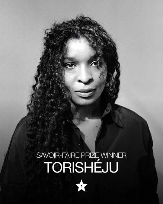Black-and-white portrait of Torishéju, winner of the Savoir-Faire Prize, looking at the camera.