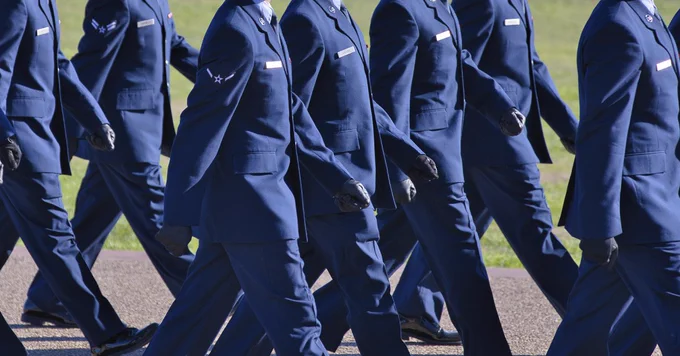 Air Force trainees marching in uniform. 